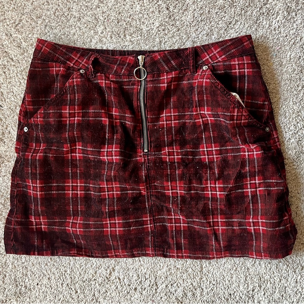 Red and black plaid corduroy mini skirt with zipper and pockets.